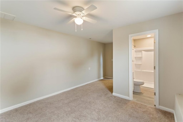 unfurnished bedroom featuring ceiling fan, a spacious closet, light carpet, and a closet