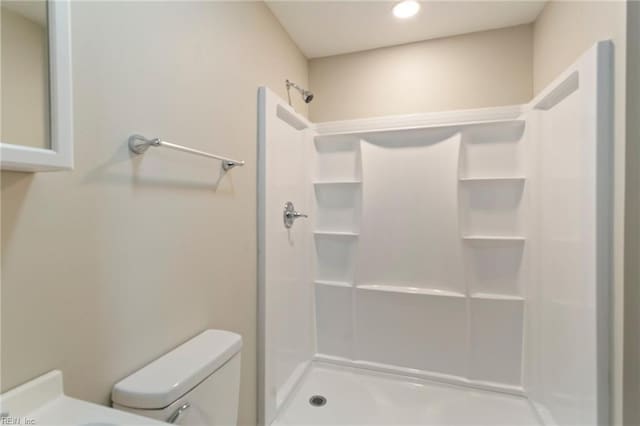 bathroom with toilet and walk in shower