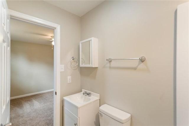 bathroom with ceiling fan, vanity, and toilet