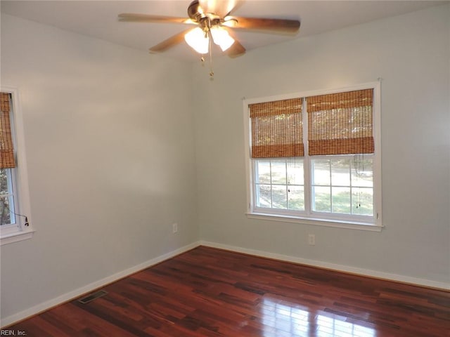 empty room featuring ceiling fan and dark hardwood / wood-style floors