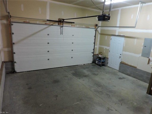 garage with electric panel and a garage door opener