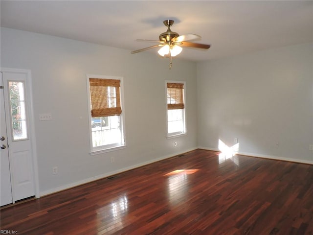 interior space with ceiling fan, a healthy amount of sunlight, and dark hardwood / wood-style floors