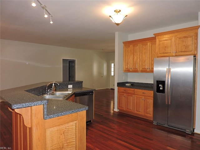 kitchen with stainless steel appliances, track lighting, dark hardwood / wood-style floors, sink, and kitchen peninsula