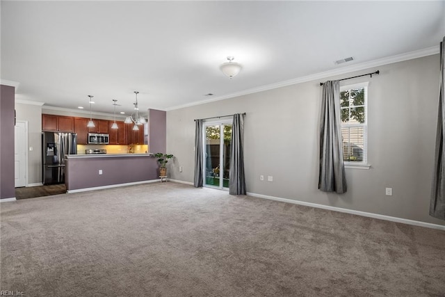 unfurnished living room with a chandelier, crown molding, and carpet