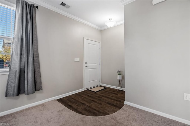 entryway featuring dark colored carpet and ornamental molding