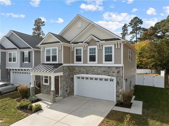 craftsman house with a front lawn and a garage