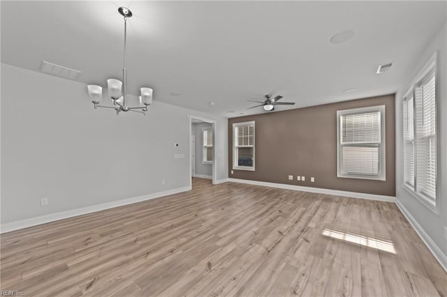 unfurnished living room with light hardwood / wood-style floors and ceiling fan with notable chandelier