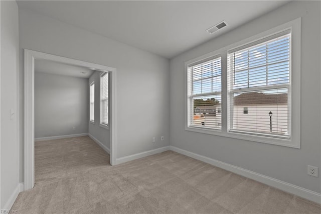 empty room featuring light carpet