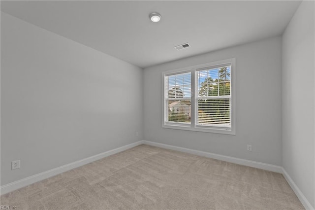 spare room with light colored carpet