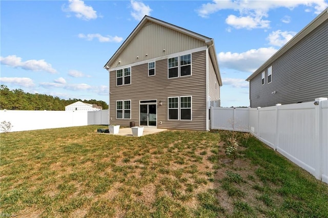 back of property with a patio area and a yard