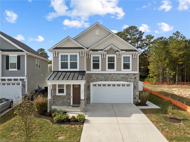 craftsman inspired home with a garage and a front lawn