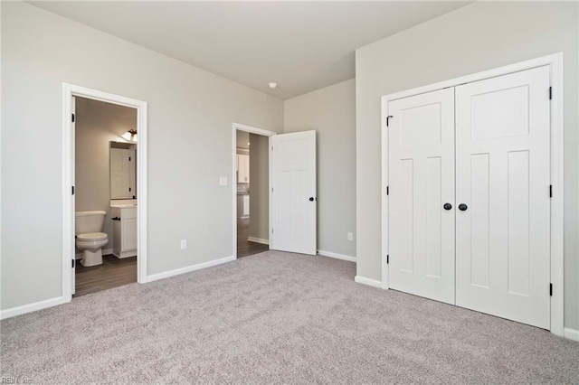 unfurnished bedroom featuring connected bathroom, a closet, and light colored carpet