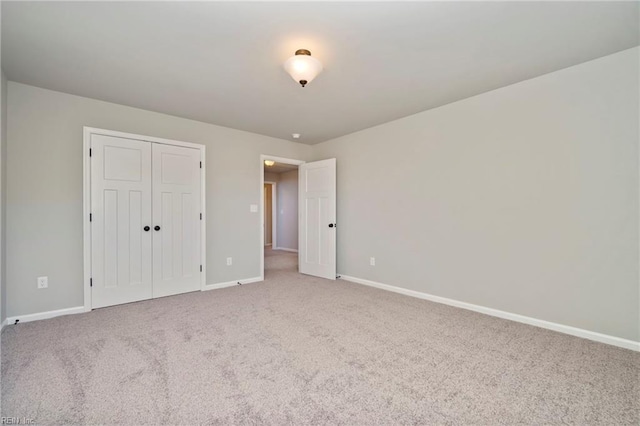 unfurnished bedroom featuring carpet flooring and a closet