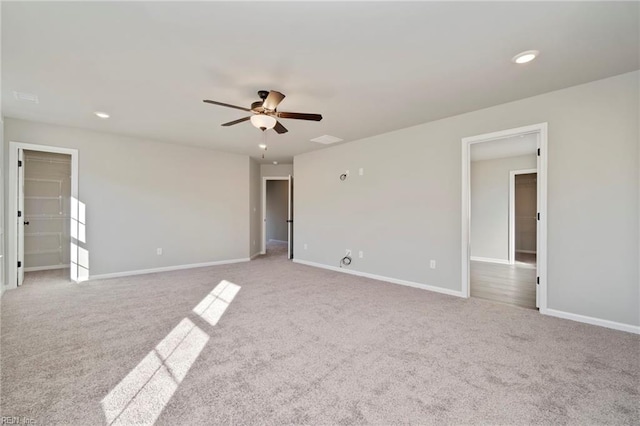 unfurnished room featuring ceiling fan and light colored carpet