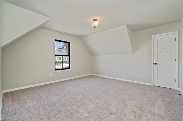 bonus room featuring lofted ceiling and carpet floors