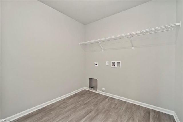 clothes washing area featuring gas dryer hookup, hookup for a washing machine, wood-type flooring, and hookup for an electric dryer