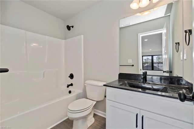 full bathroom with hardwood / wood-style floors, tub / shower combination, toilet, and vanity