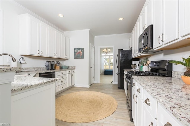 5039 Annapolis Dr, Chesapeake, VA 23321 - kitchen with black appliances, a chandelier, white cabinetry, light stone counters, and crown molding