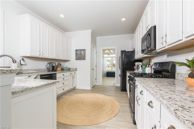 kitchen with white cabinetry, black appliances, crown molding, and light stone countertops