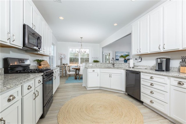 5039 Annapolis Dr, Chesapeake, VA 23321 - kitchen with black appliances, a sink, white cabinetry, light wood-style flooring, and a chandelier