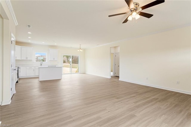 unfurnished living room with crown molding, baseboards, recessed lighting, light wood-style floors, and a ceiling fan