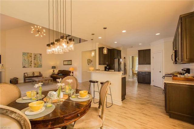 5043 Annapolis Dr, Chesapeake, VA 23321 - dining space featuring light wood finished floors, recessed lighting, ornamental molding, and a chandelier
