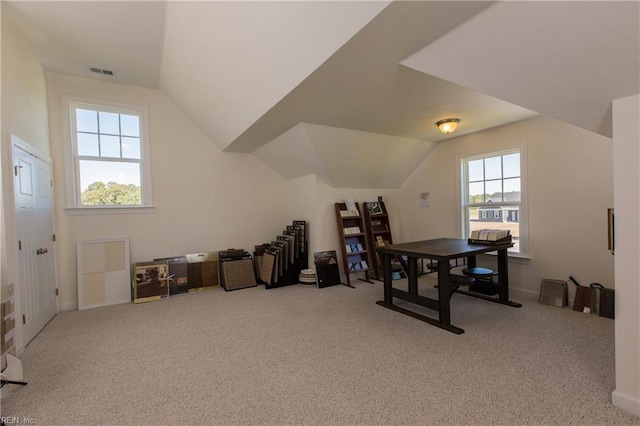 interior space featuring light colored carpet and lofted ceiling