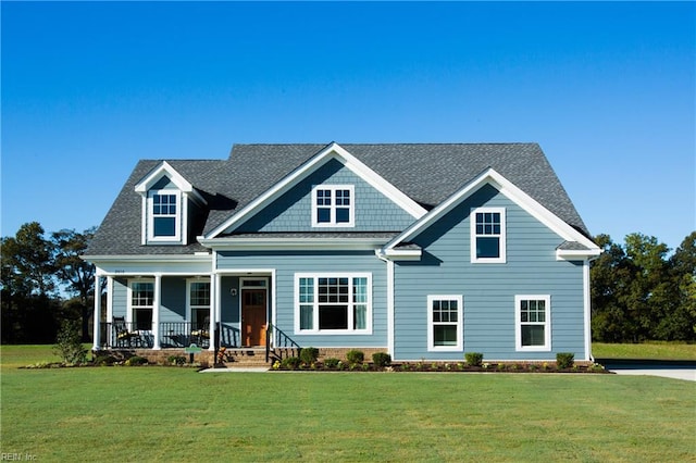 5043 Annapolis Dr, Chesapeake, VA 23321 - view of front facade featuring a porch, a front lawn, and a shingled roof
