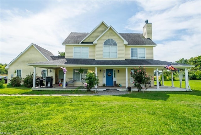 view of front of home featuring a front yard and a porch