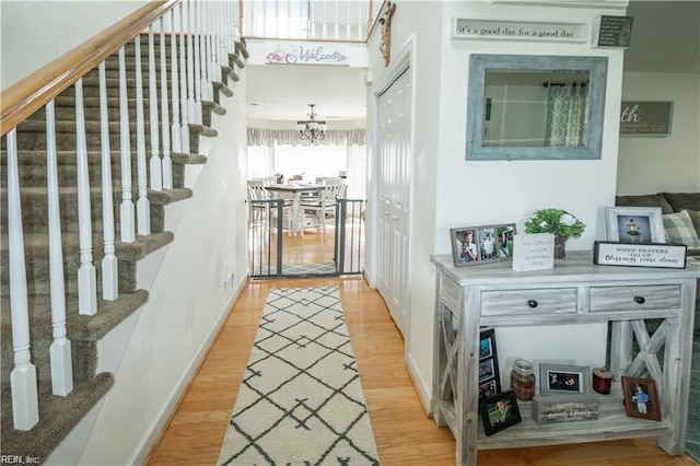 hallway featuring a chandelier and hardwood / wood-style floors