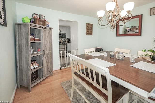 dining room with a chandelier and light hardwood / wood-style floors