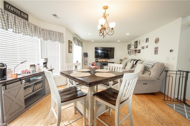 dining area featuring a chandelier and light wood-type flooring