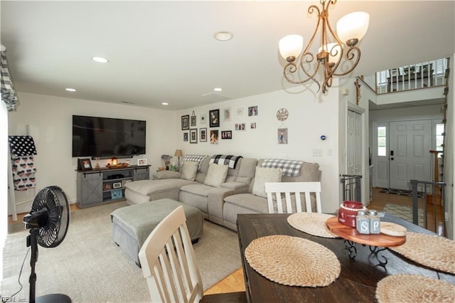 carpeted dining area with an inviting chandelier