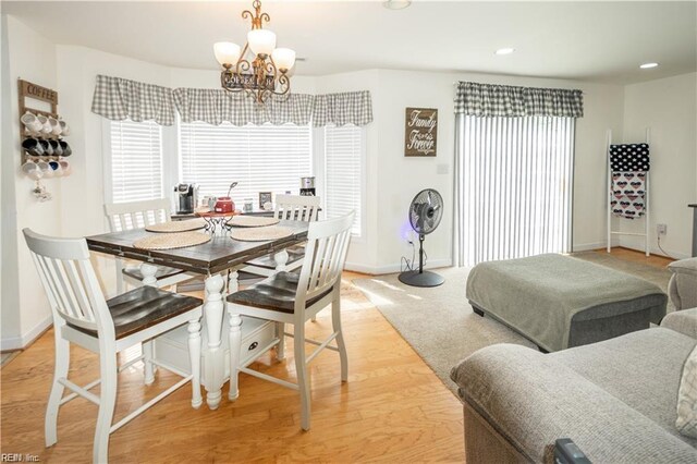 dining room featuring light hardwood / wood-style floors and a chandelier