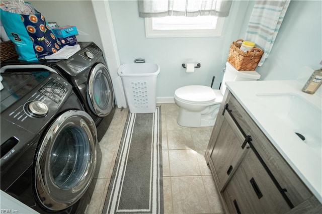 bathroom featuring vanity, tile patterned flooring, toilet, and washer and clothes dryer