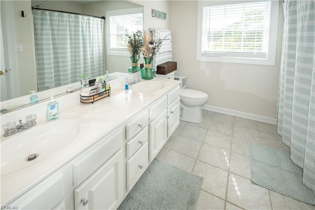 bathroom featuring vanity, tile patterned floors, and toilet