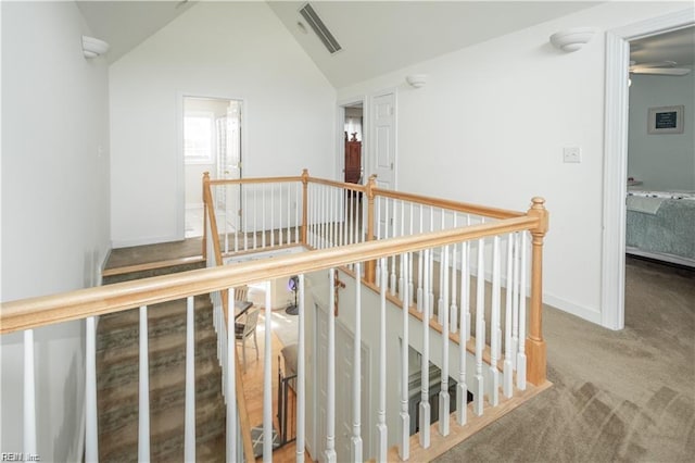 hall with lofted ceiling and carpet flooring