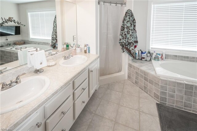 bathroom with vanity, tile patterned floors, and shower with separate bathtub