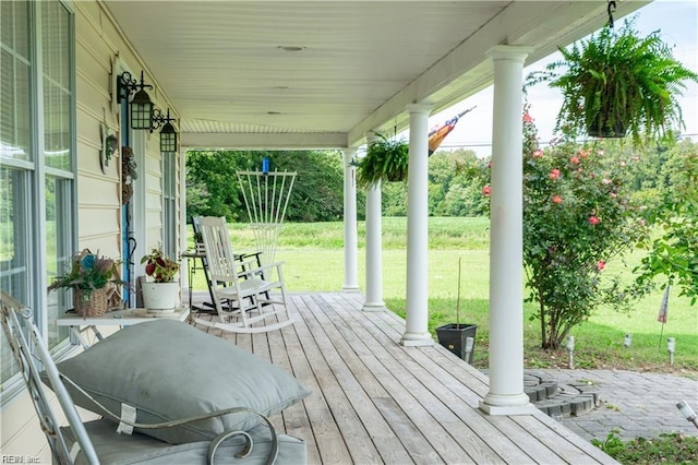 wooden terrace featuring a yard