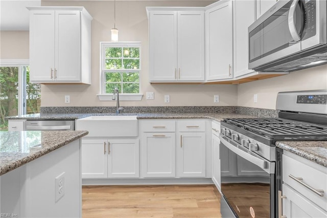 kitchen with white cabinetry and stainless steel appliances