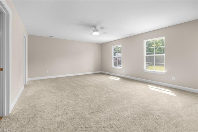 carpeted spare room with ceiling fan