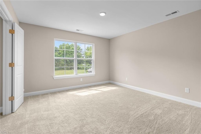 empty room featuring light colored carpet