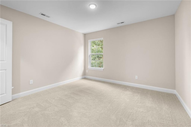 empty room featuring light colored carpet