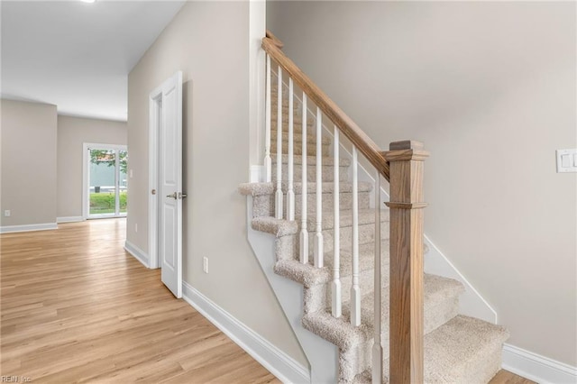 staircase with wood-type flooring