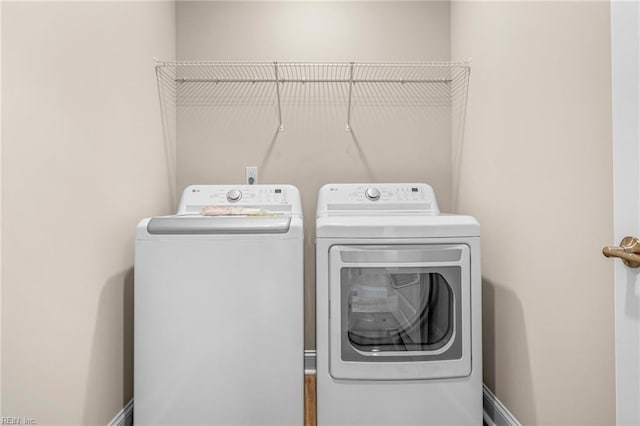 clothes washing area featuring washing machine and clothes dryer