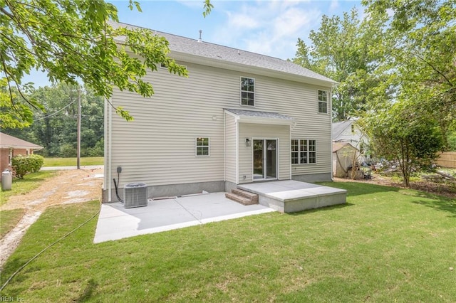 rear view of house featuring central AC unit, a patio area, and a lawn