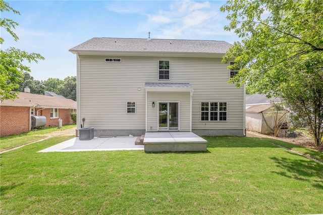 rear view of property with central AC unit, a patio, and a yard