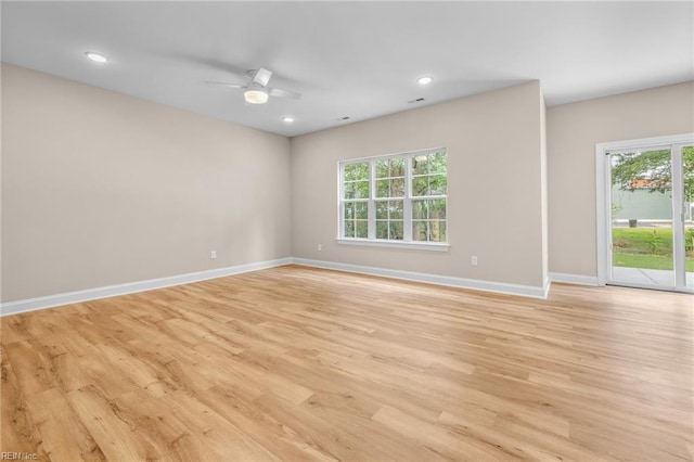 spare room featuring light wood-type flooring and ceiling fan