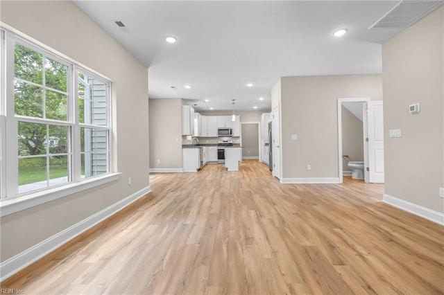 unfurnished living room with light hardwood / wood-style flooring