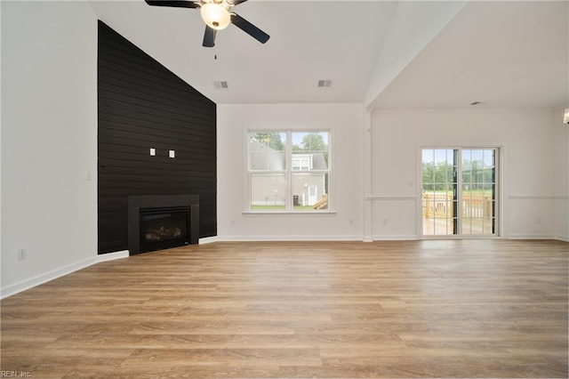 unfurnished living room featuring high vaulted ceiling, ceiling fan, light hardwood / wood-style floors, and a large fireplace